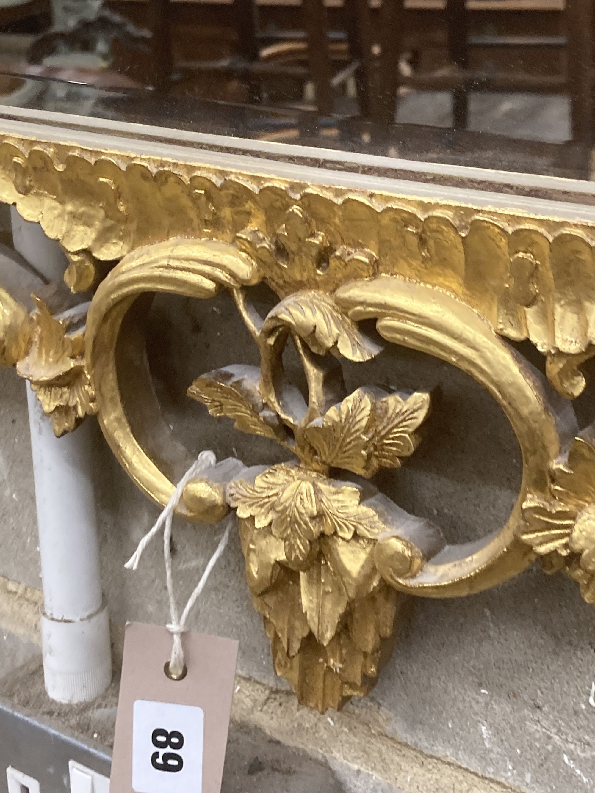 A George III style decorative carved giltwood wall mirror, width 63cm, height 106cm